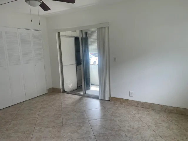 an empty room with a empty space and windows