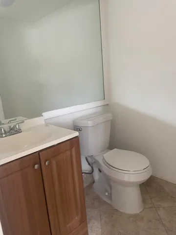 a bathroom with a sink a toilet and a mirror