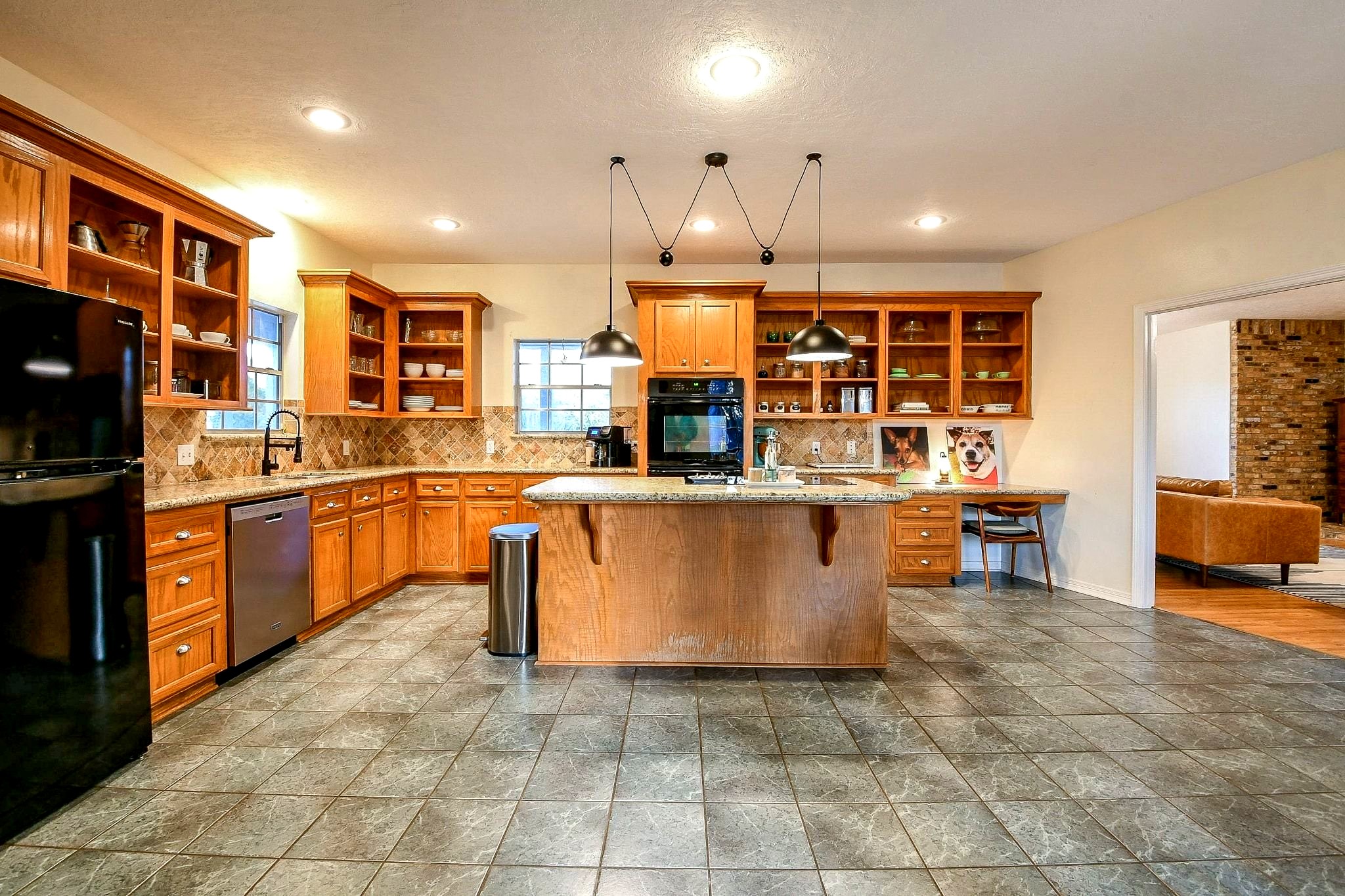22035 Buescher Road Tomball, TX 77377 - Photo 13 of 43 a kitchen with stainless steel appliances a stove a sink a oven a window and kitchen view