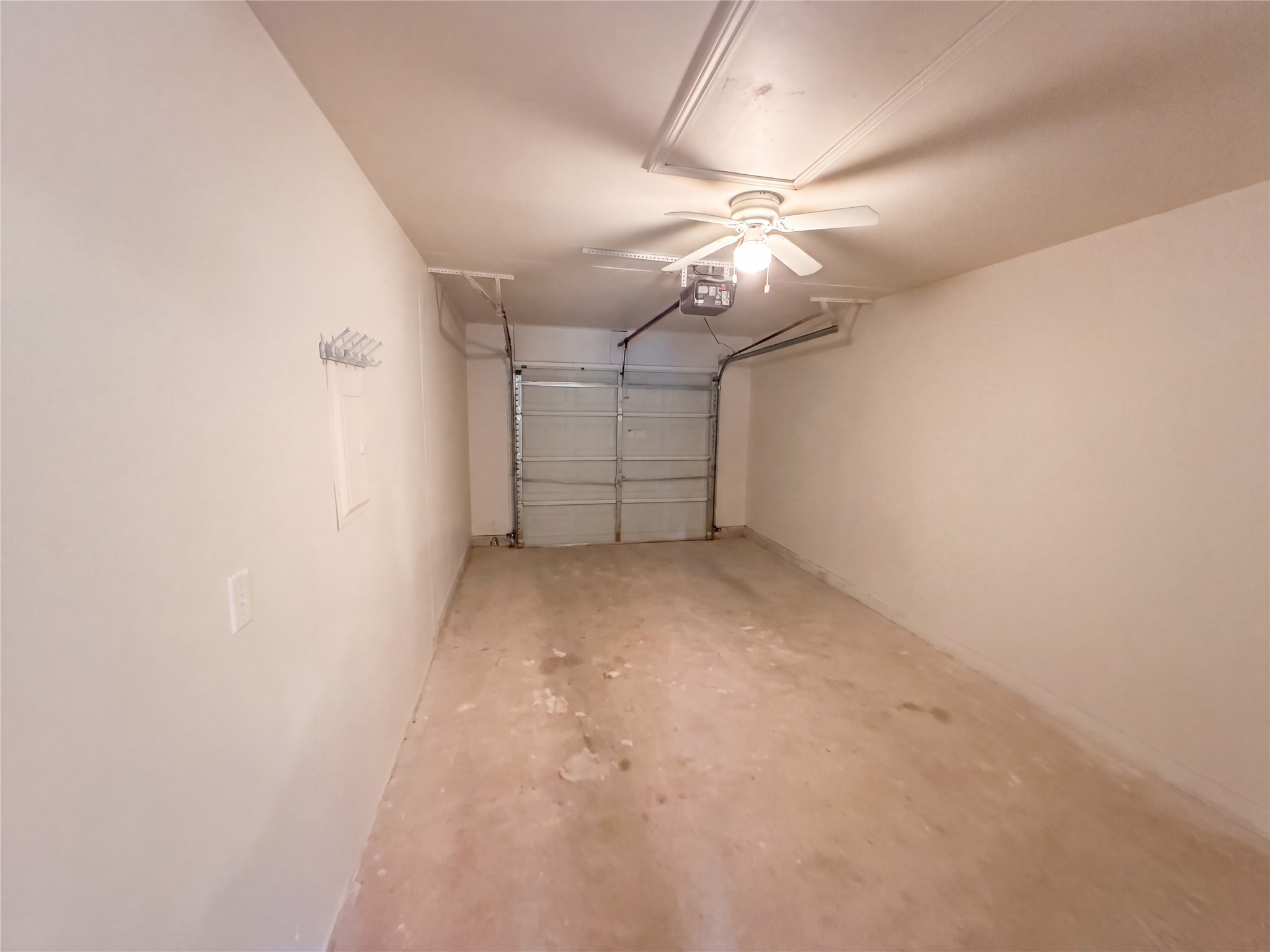 172 Prairie Springs Loop Georgetown, TX 78626 - Photo 21 of 32 An attached single-car garage features a solid concrete floor and practical attic access panel.