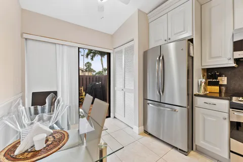 a kitchen with stainless steel appliances granite countertop a refrigerator and a stove