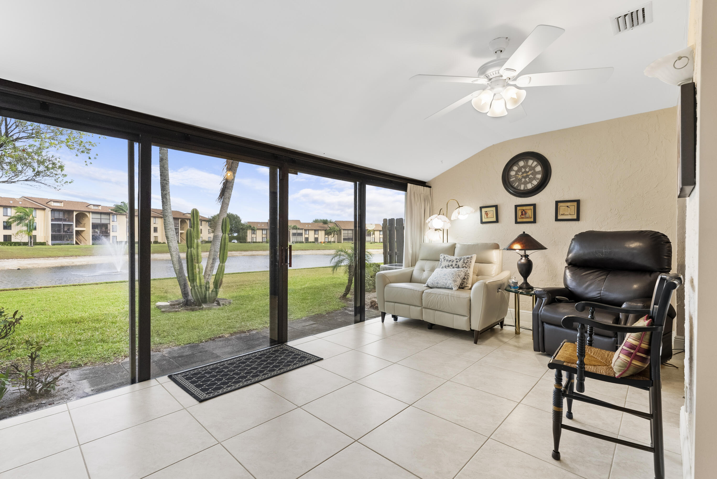 823 Sky Pine Way, Unit D Greenacres, FL 33415 - Photo 15 of 34 a living room with furniture and a floor to ceiling window