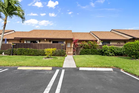 a front view of house with yard street and outdoor seating
