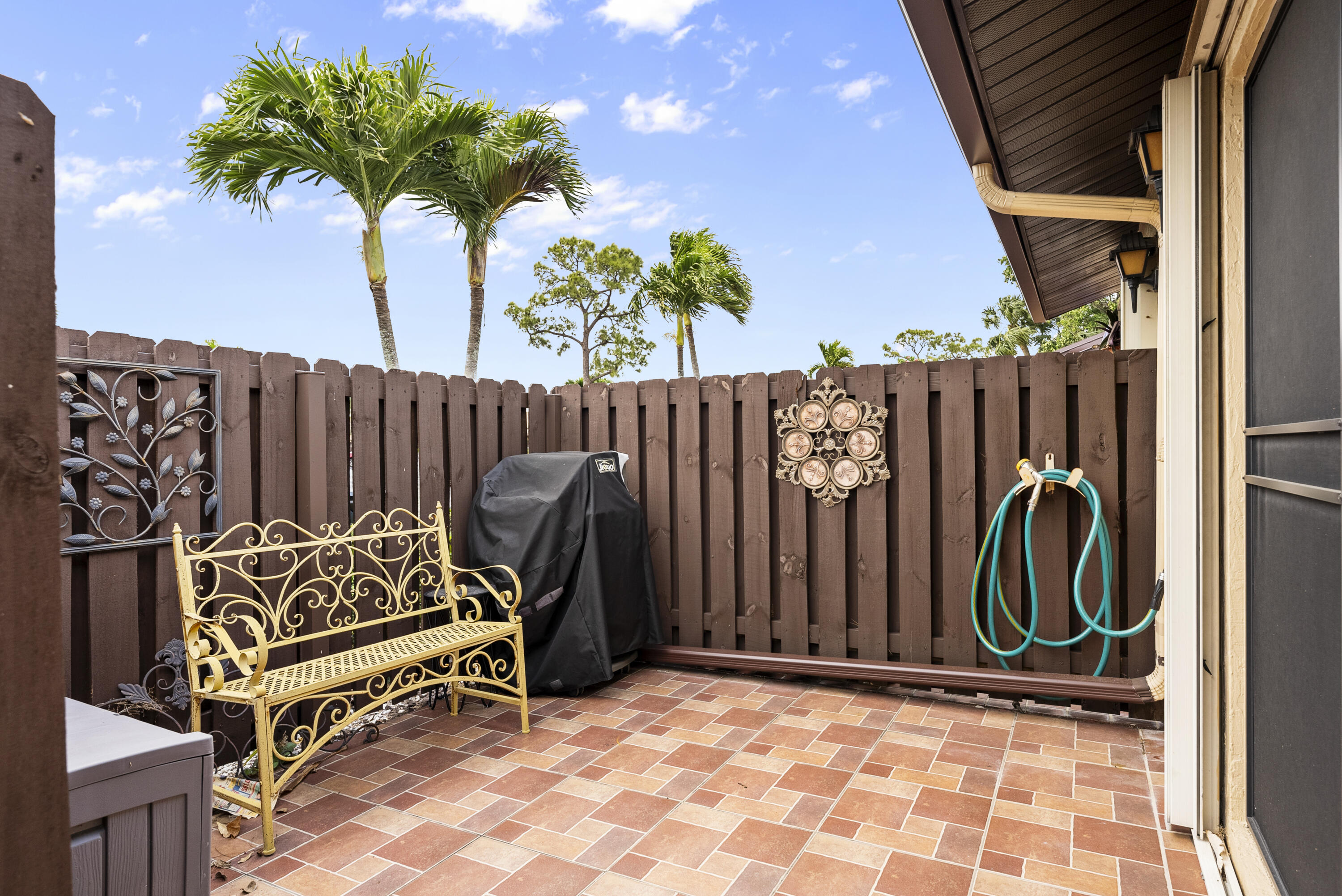 823 Sky Pine Way, Unit D Greenacres, FL 33415 - Photo 29 of 34 a view of outdoor space with deck and furniture