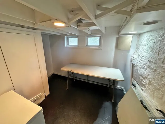 a room with pool table and windows