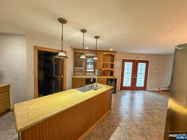 a room with pool table and windows