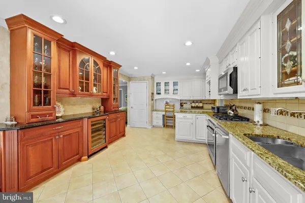 a large kitchen with stainless steel appliances and cabinets