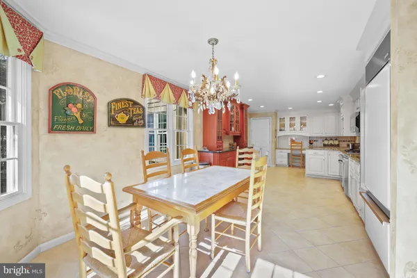 a view of a dining room with furniture and chandelier