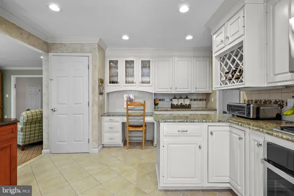 a kitchen with granite countertop a stove a sink and a cabinets