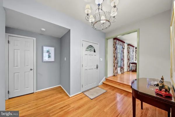 a view of a livingroom with wooden floor and furniture