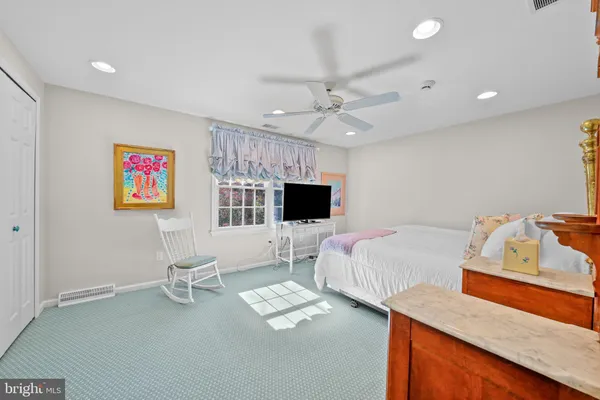a bedroom with a large bed and a chandelier