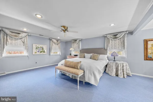 a bedroom with a bed and a couch