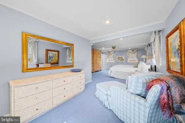 a spacious bathroom with a sink a toilet a large mirror and shower