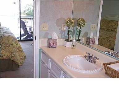 63 Sandy Lane, Unit 101 Santa Rosa Beach, FL 32459 - Photo 9 of 11 a bathroom with a tub sink and mirror