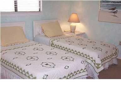 63 Sandy Lane, Unit 101 Santa Rosa Beach, FL 32459 - Photo 10 of 11 a bedroom with a bed and a lamp