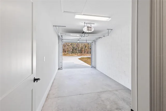 a view of a kitchen with wooden floor and a ceiling fan