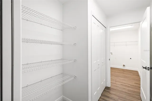 a view of a refrigerator in kitchen and wooden floor