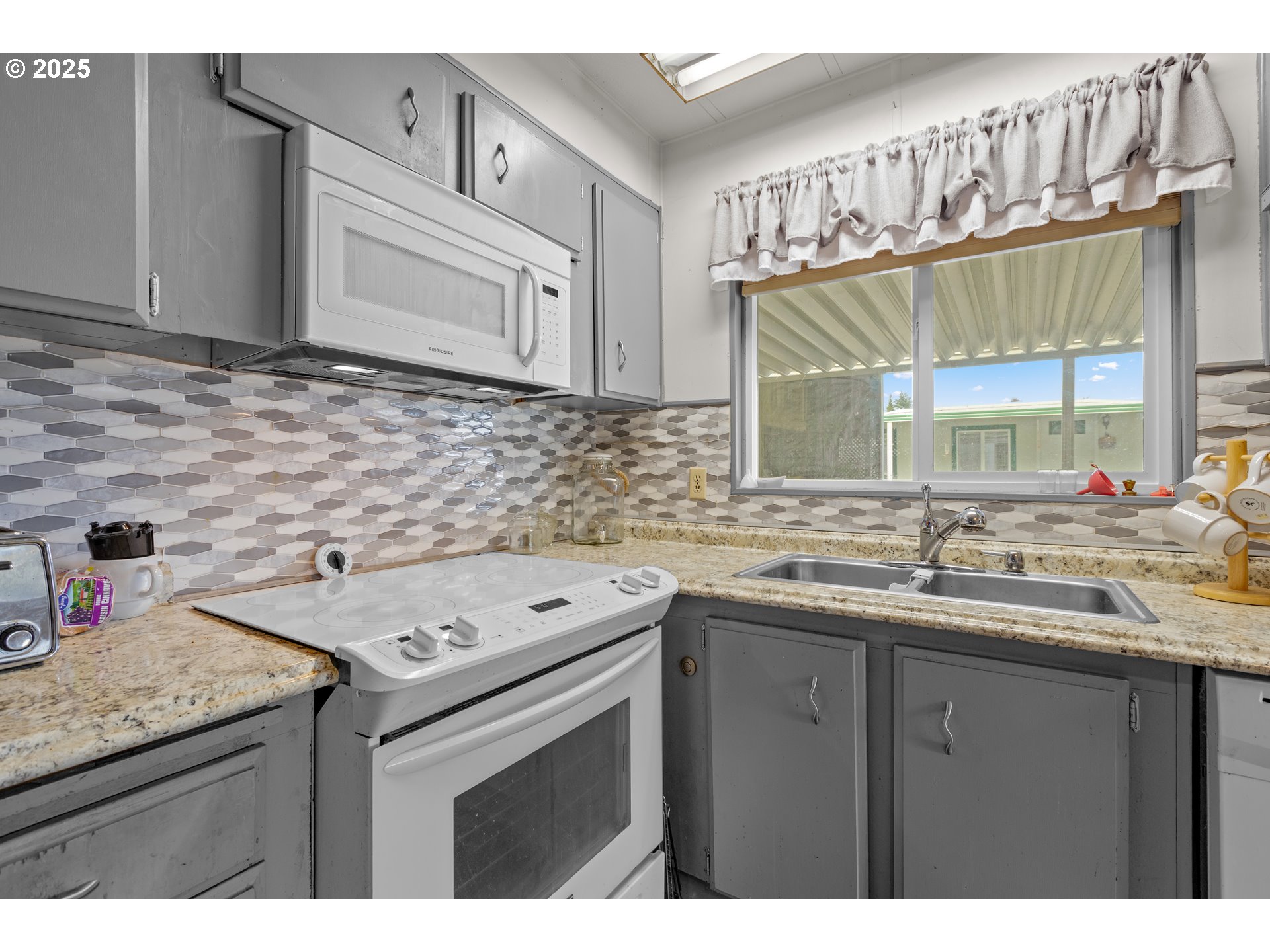 125 Estate Loop Winston, OR 97496 - Photo 16 of 45 a kitchen with a sink cabinets and window