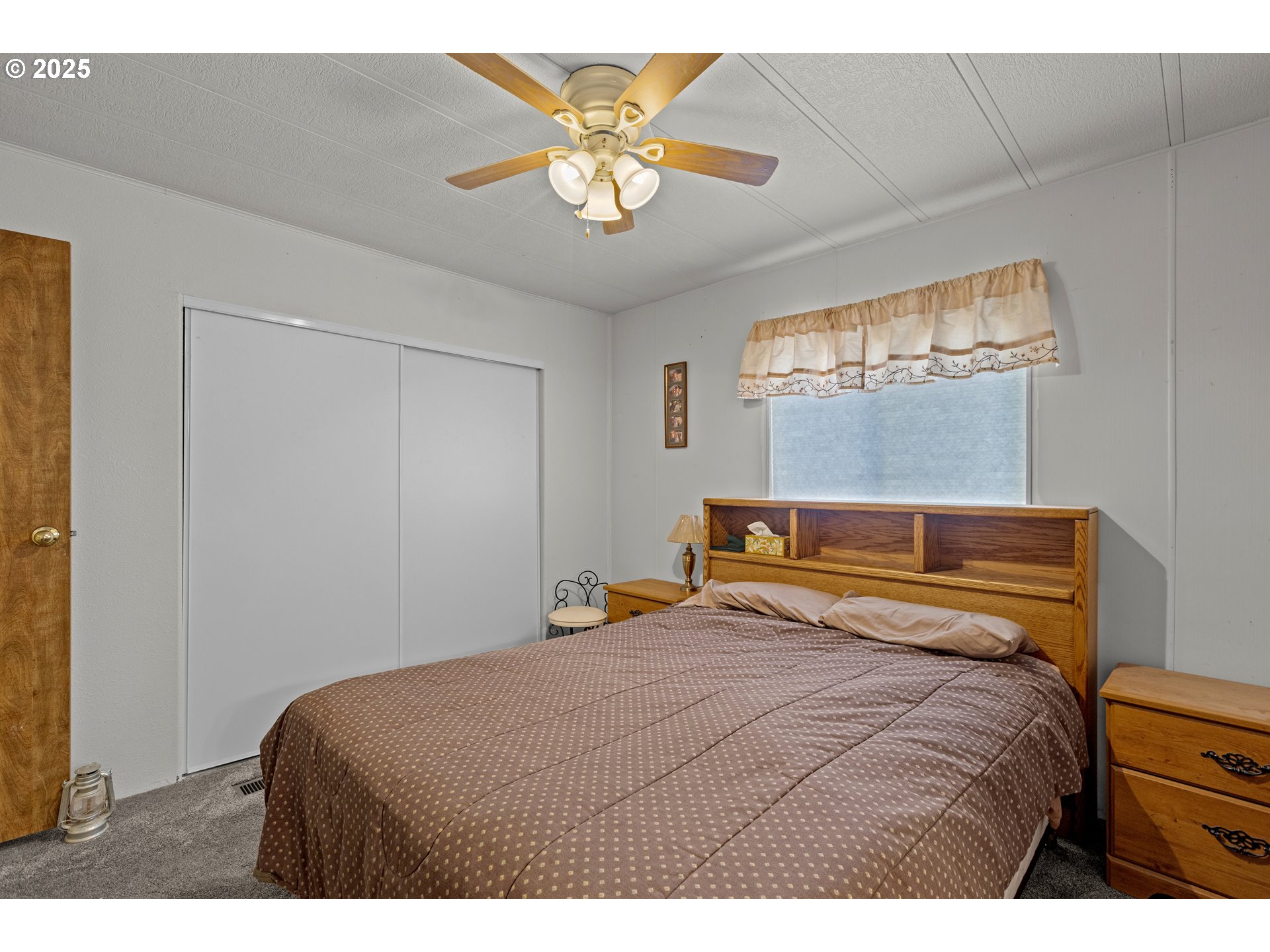 125 Estate Loop Winston, OR 97496 - Photo 20 of 45 a bedroom with a bed and a chandelier