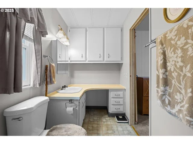 a kitchen with a sink a refrigerator and cabinets