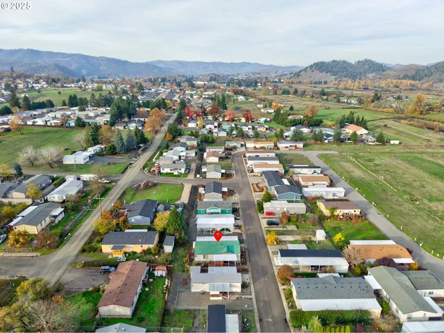 an aerial view of residential houses with outdoor space and river view
