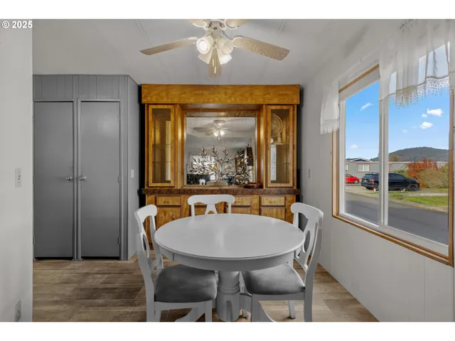 a dining room with furniture and a window