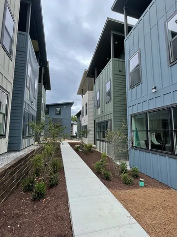 a view of a house with brick walls