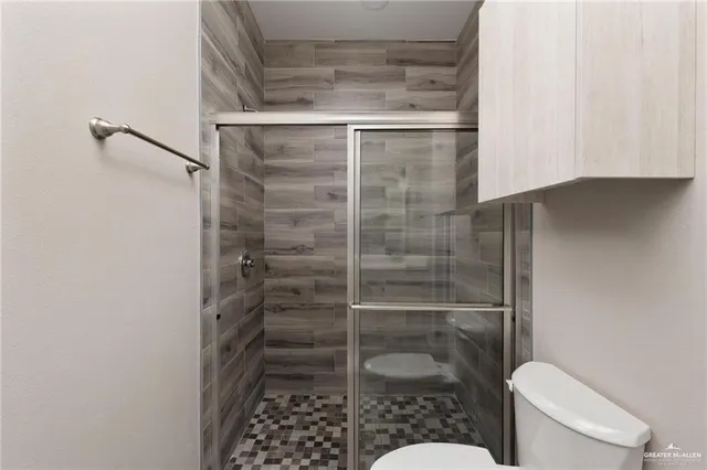 a bathroom with a toilet and a shower
