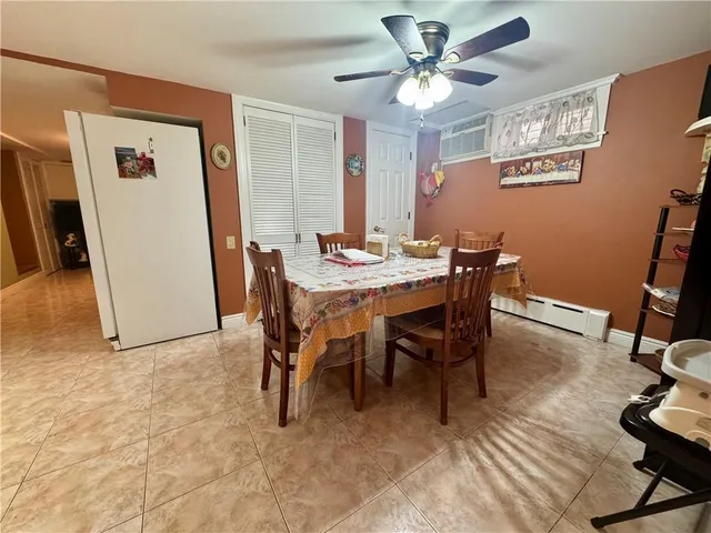 a view of a dining room with furniture and a chandelier fan