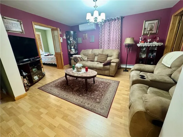a living room with furniture a rug and a flat screen tv
