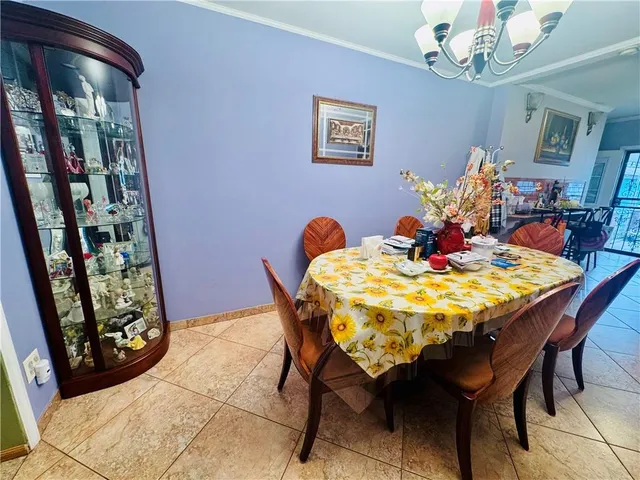 a dining room with furniture and chandelier