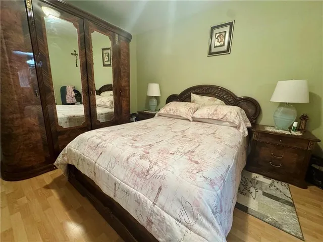 a bedroom with a bed and a mirror