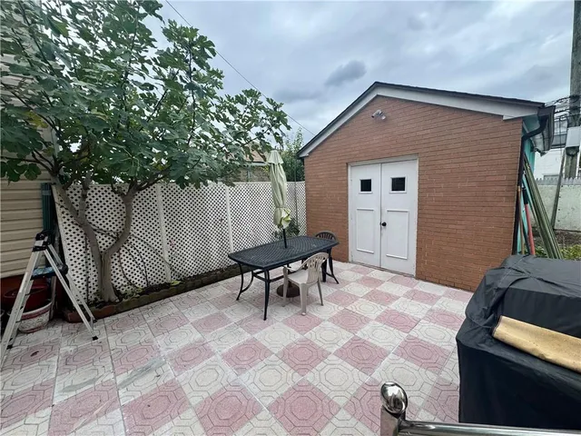 a backyard of a house with table and chairs