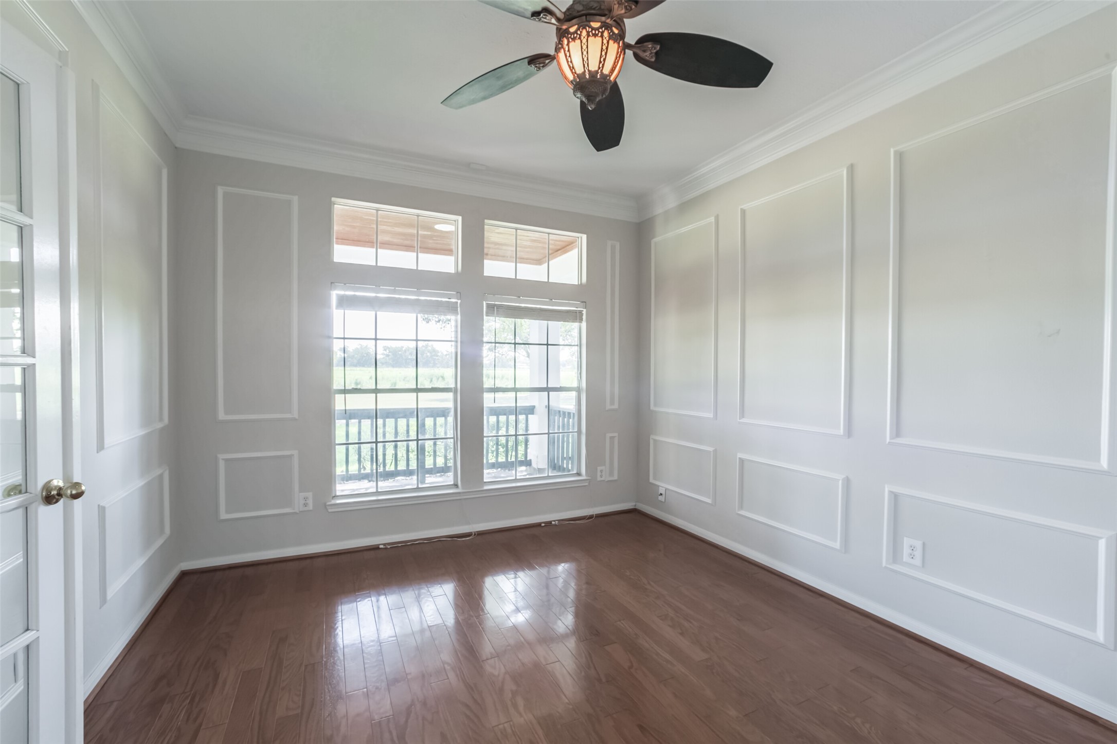 4903 Bowser Road Fulshear, TX 77441 - Photo 11 of 50 a view of an empty room with wooden floor and a window