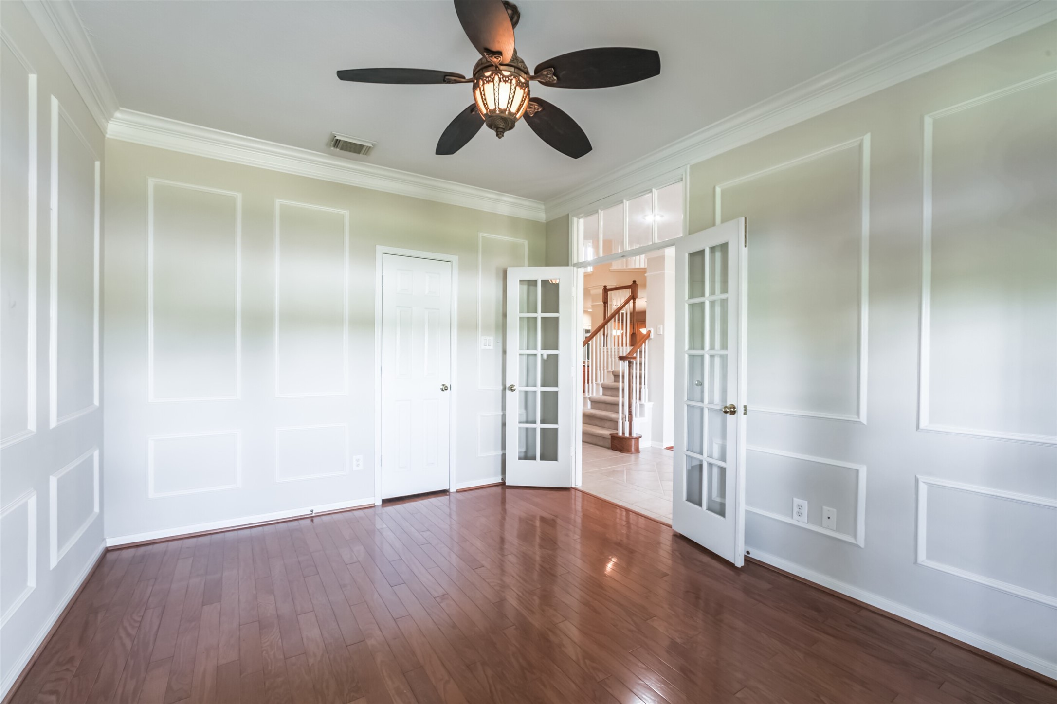 4903 Bowser Road Fulshear, TX 77441 - Photo 12 of 50 a view of empty room with wooden floor and fan