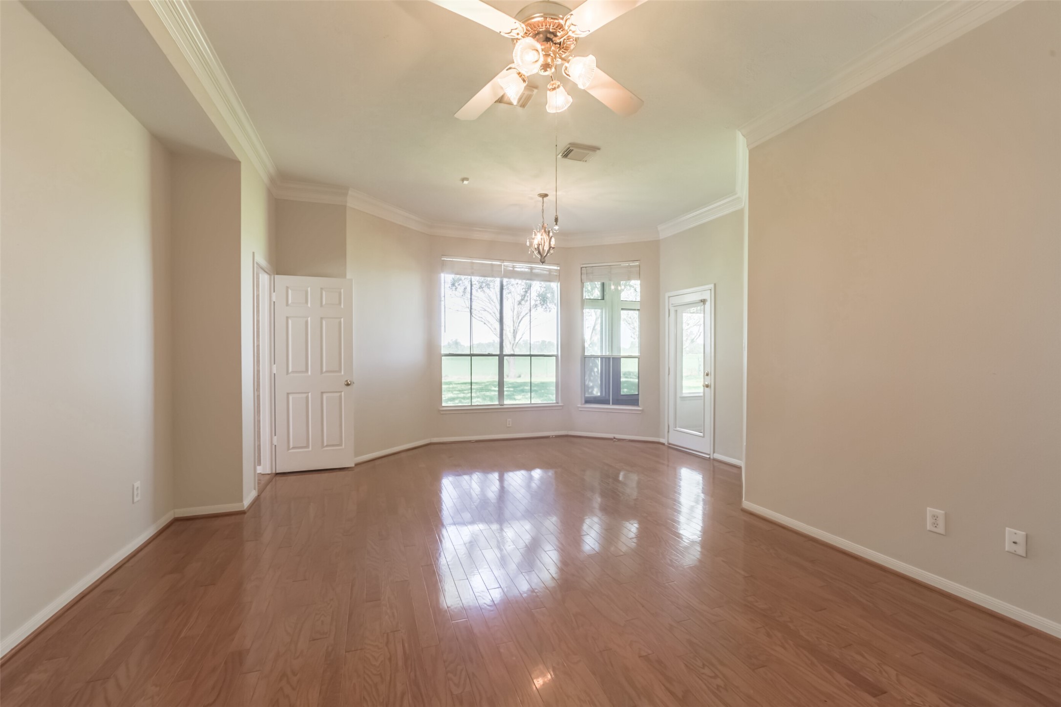4903 Bowser Road Fulshear, TX 77441 - Photo 19 of 50 Primary bedroom with wood floors and sitting area overlooking the back yard