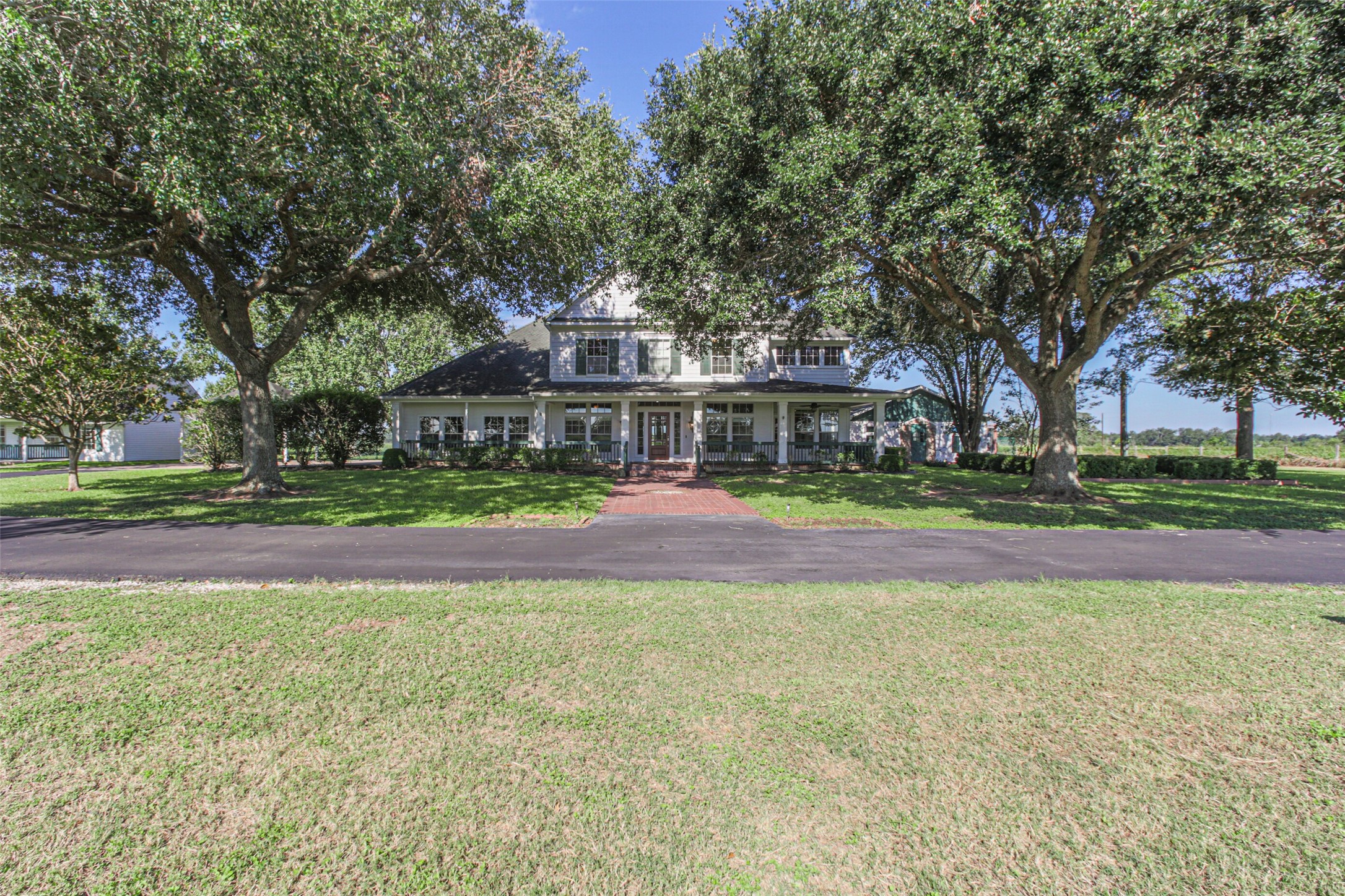 4903 Bowser Road Fulshear, TX 77441 - Photo 4 of 50 a view of large trees in front of a house