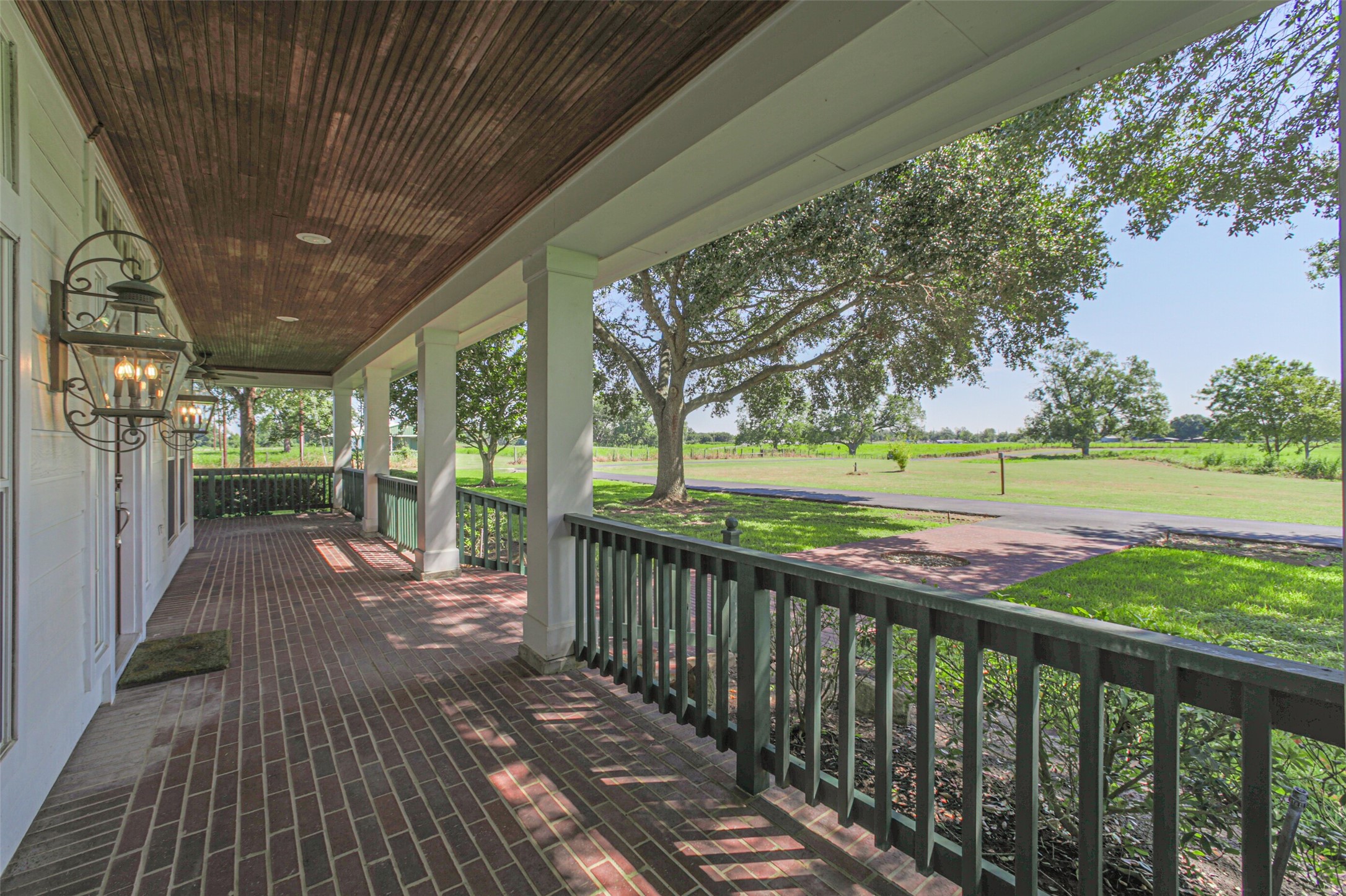 4903 Bowser Road Fulshear, TX 77441 - Photo 6 of 50 a view of a porch with wooden floor and fence