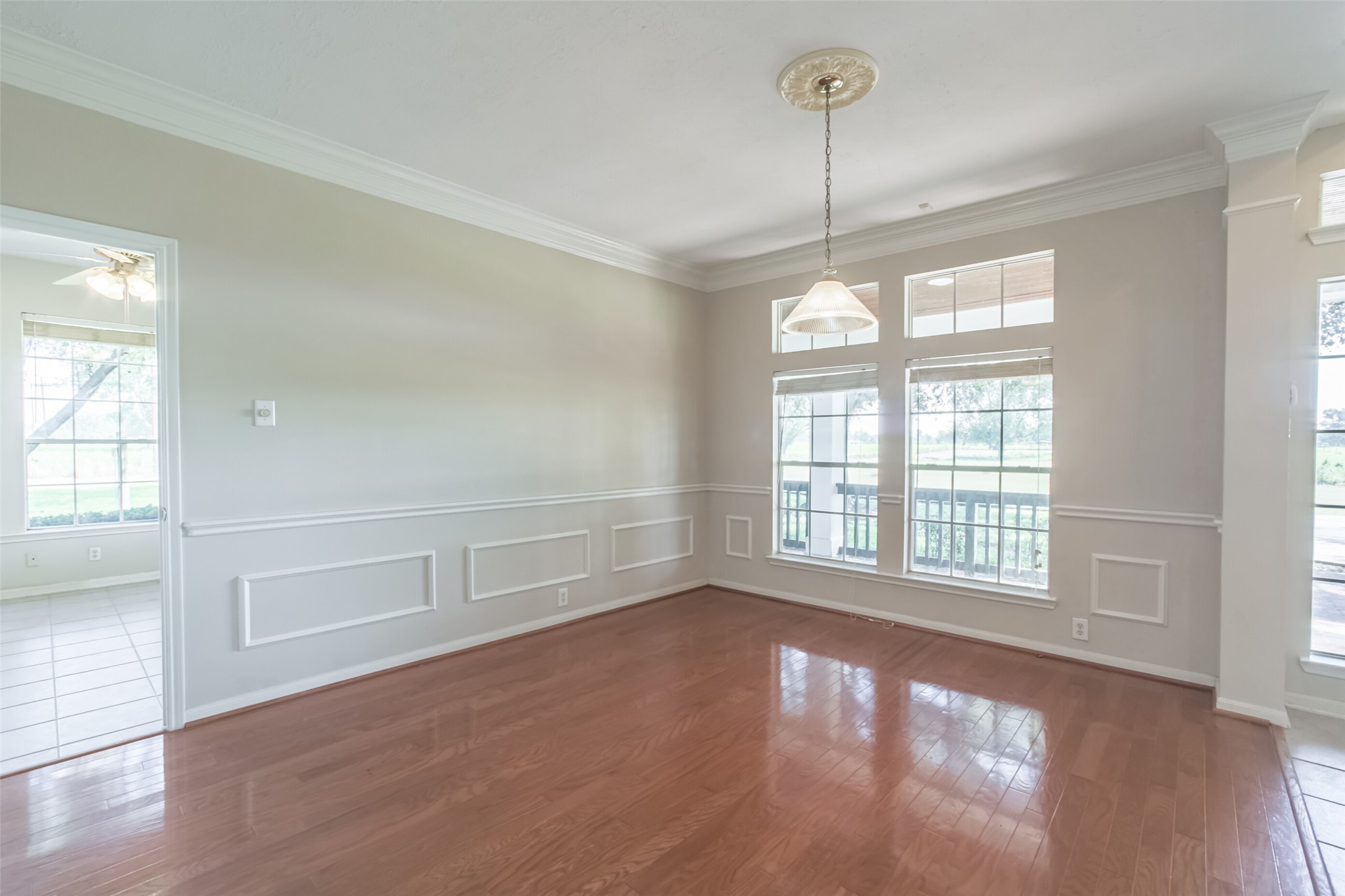 4903 Bowser Road Fulshear, TX 77441 - Photo 10 of 50 an empty room with wooden floor and windows