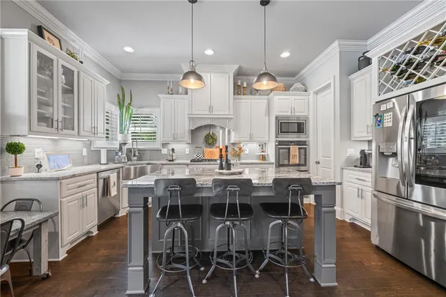 a large kitchen with a table and chairs