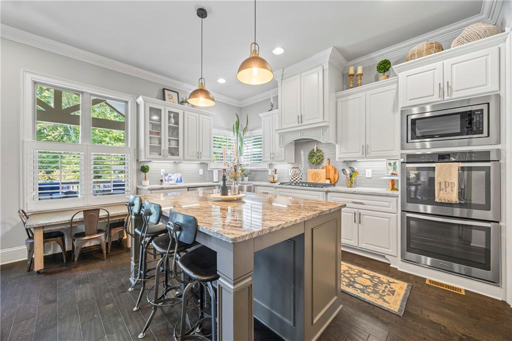 3111 Old Thompson Mill Road Buford, GA 30519 - Photo 15 of 52 a kitchen with granite countertop a stove a sink and a refrigerator