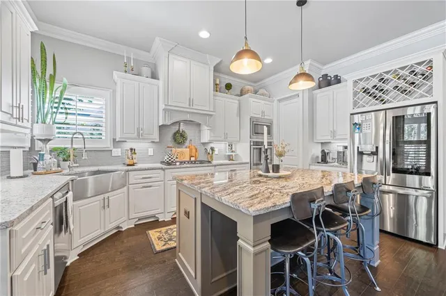 a kitchen with a table chairs stove and cabinets