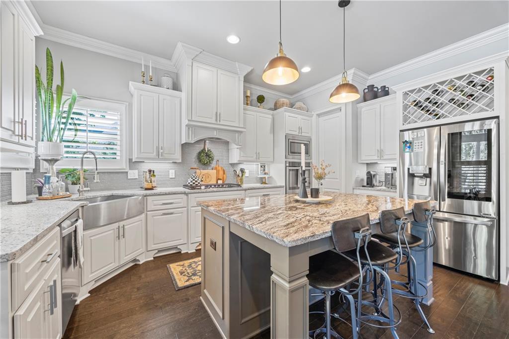 3111 Old Thompson Mill Road Buford, GA 30519 - Photo 19 of 52 a kitchen with a table chairs stove and cabinets