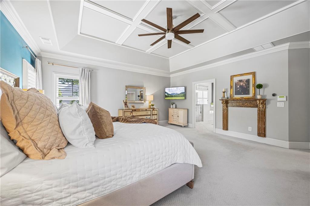 3111 Old Thompson Mill Road Buford, GA 30519 - Photo 26 of 52 a bedroom with a large bed and a chandelier