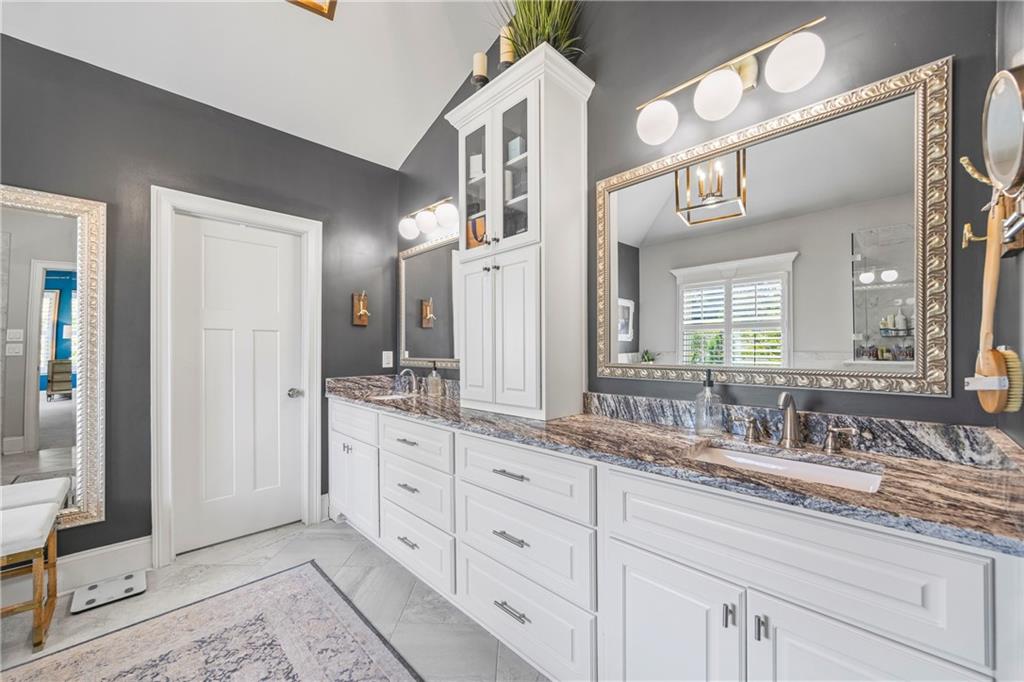 3111 Old Thompson Mill Road Buford, GA 30519 - Photo 28 of 52 a bathroom with a granite countertop double vanity sink and a mirror