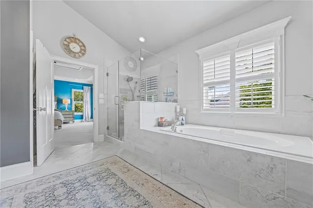 a view of a hallway with wooden floor and chandelier