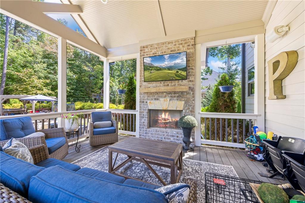 3111 Old Thompson Mill Road Buford, GA 30519 - Photo 40 of 52 a living room with furniture a fireplace and a floor to ceiling window