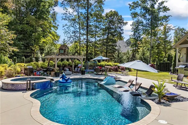 an aerial view of a house with a yard and fountain in front of it