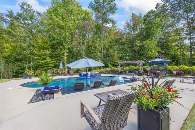 an outdoor sitting area with furniture and umbrella
