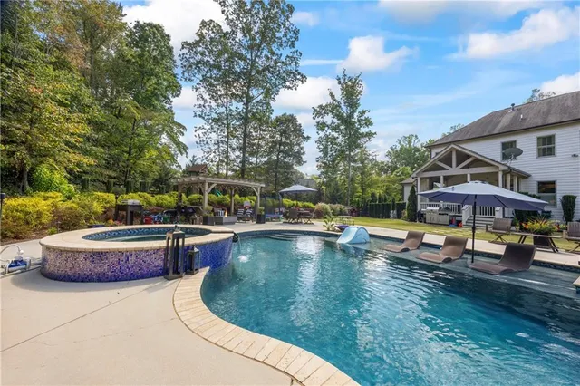 a view of a chairs and tables in the patio and a fountain in the patio